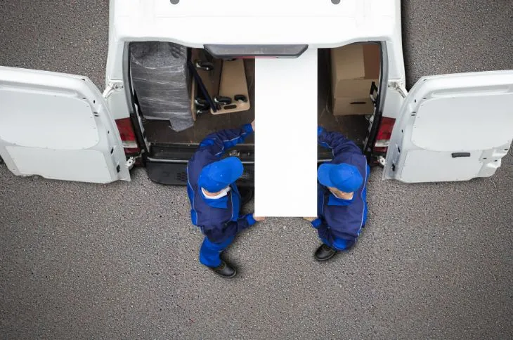 Group of movers unloading a moving truck.